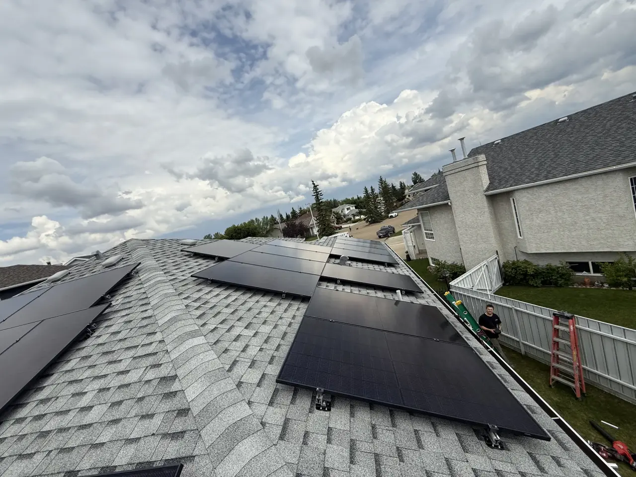 Solar panels being installed on a suburban home in Leduc