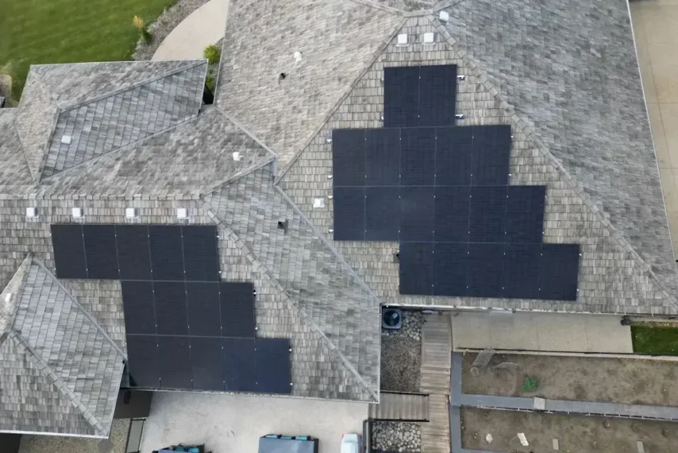 Close-up aerial view of 42 solar panels installed across the cedar shake roof of Sandra Mitchell's Parkland County home