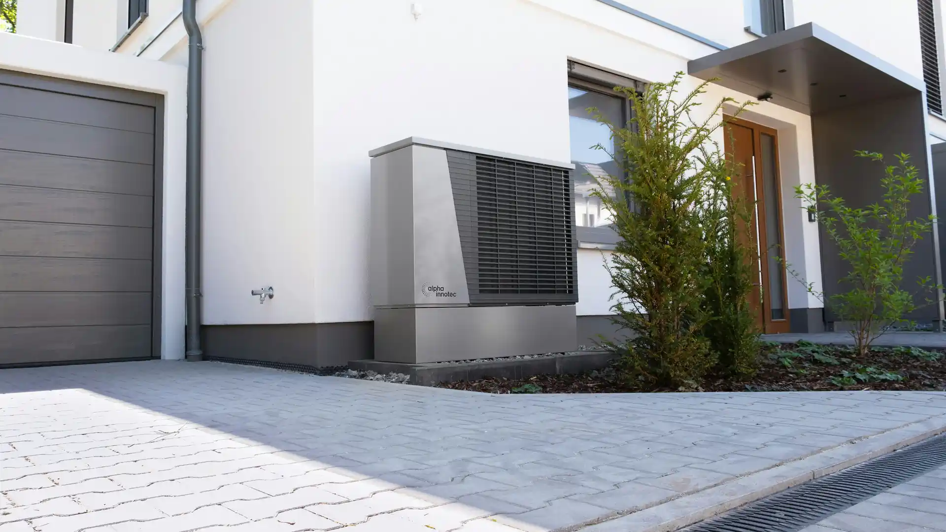 Modern home with an outdoor heat pump beside the entrance